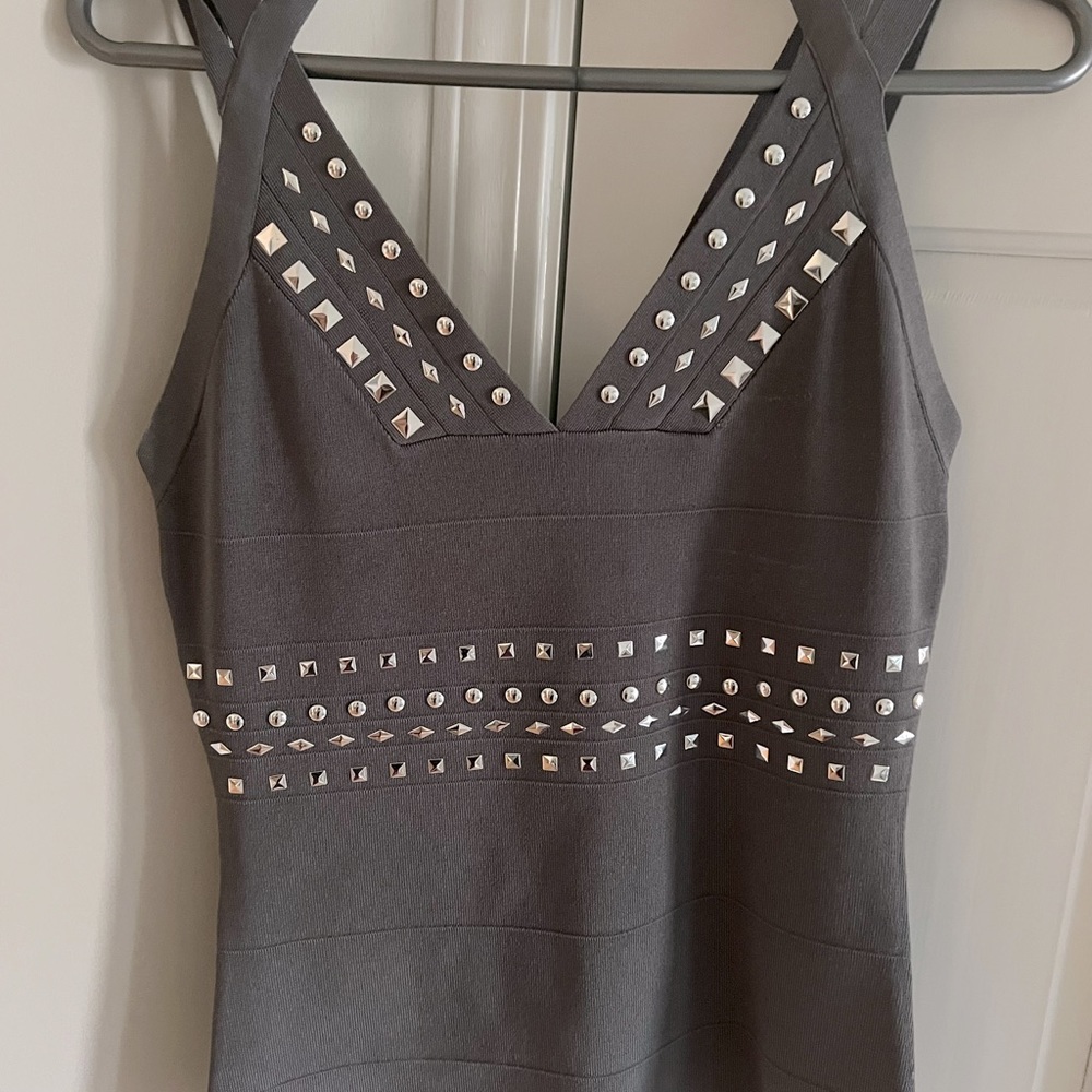 Gray w/silver rivets Cache tank. 65%Rayon, 32% Nylon, 3% Spandex. Nicely fitted
